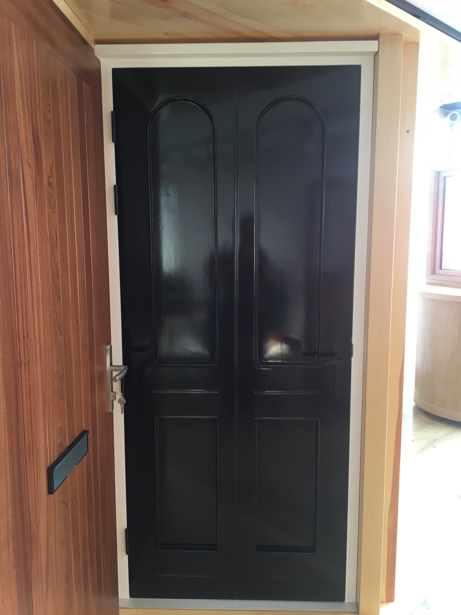 Four panel hardwood front door, factory fully finished in two colours - inside white and outside black. Multi point lock.
