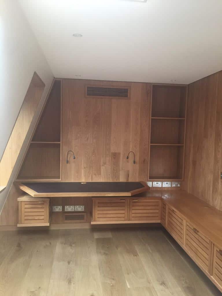Office with floating file storage. Bespoke loft TV unit with storage in Zibrano finish. Engineered wood flooring.